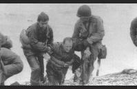 E-2) Survivors from a destroyed Higgins Boat at Omaha Beach. US Army Signal Corps