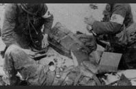 E-3) U.S. medics tend to the wounded on Utah Beach. US Army Signal Corps